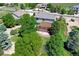 An aerial view showcasing the well-maintained home with a patio pergola and established landscaping at 8720 E 163Rd Pl, Brighton, CO 80602