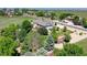 Aerial view of the home featuring mature trees, landscaping, a backyard pergola and proximity to open space at 8720 E 163Rd Pl, Brighton, CO 80602