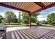 Outdoor patio featuring a wood pergola and concrete pad with views of the lush, green backyard at 8720 E 163Rd Pl, Brighton, CO 80602