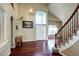 Inviting foyer with soaring ceilings, curved staircase, hardwood floors and large windows at 8720 E 163Rd Pl, Brighton, CO 80602
