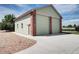 Detached two-car garage with brick accents, matching the main home's exterior design at 8720 E 163Rd Pl, Brighton, CO 80602