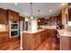 Gourmet kitchen with stainless steel appliances, granite countertops, and custom cabinetry at 8720 E 163Rd Pl, Brighton, CO 80602