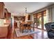 Spacious eat-in kitchen with wood cabinets, hardwood floors, and sliding doors to the backyard at 8720 E 163Rd Pl, Brighton, CO 80602