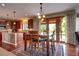 Eat-in kitchen with wood floors, breakfast table on rug, and sliding doors to the outdoor patio area at 8720 E 163Rd Pl, Brighton, CO 80602