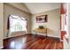 Bright sitting room with vaulted ceilings, large window, hardwood floors and picture on the wall at 8720 E 163Rd Pl, Brighton, CO 80602