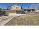 Two-story home featuring a two car garage, stone facade, and a well-manicured front yard at 9435 N Osceola St, Westminster, CO 80031