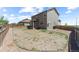 Spacious backyard with wooden fence, grass, and view of the house's exterior at 603 Jewel St, Brighton, CO 80603
