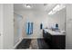 Bathroom featuring double sinks, a walk-in shower, and neutral décor at 603 Jewel St, Brighton, CO 80603