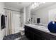 Well-lit bathroom with a double sink vanity, large mirror, shower, and modern fixtures at 603 Jewel St, Brighton, CO 80603