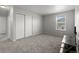 Bright bedroom with neutral walls, carpeted floors, a closet, and a window providing natural light at 603 Jewel St, Brighton, CO 80603