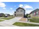 Charming two-story home features a well-manicured lawn, attached two car garage, and stone detailing at 603 Jewel St, Brighton, CO 80603