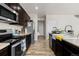 Contemporary kitchen with stainless steel appliances, a large sink, and dark cabinetry at 603 Jewel St, Brighton, CO 80603
