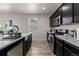 Bright kitchen features dark cabinets, stainless steel appliances, and wood-look flooring at 603 Jewel St, Brighton, CO 80603