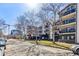 Charming building exterior featuring manicured lawns, mature trees, and a street view at 345 Fillmore St # 203, Denver, CO 80206