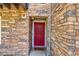 The unit's front door features brick accents and a welcome mat at 2763 W Riverwalk Cir # B, Littleton, CO 80123