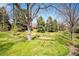 The beautiful grassy backyard has mature trees at 2615 Oak Dr # 7, Lakewood, CO 80215