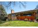 The home features a covered porch and fenced in yard at 2615 Oak Dr # 7, Lakewood, CO 80215