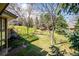 Lush backyard featuring mature trees and a gently sloping lawn at 2615 Oak Dr # 7, Lakewood, CO 80215