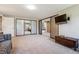 Bonus room has a mounted television and large closet doors at 2615 Oak Dr # 7, Lakewood, CO 80215