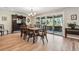 A dining room is presented with a wood table and chairs and a sliding glass door to the backyard at 2615 Oak Dr # 7, Lakewood, CO 80215