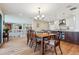 Open concept dining room features wood floors, a chandelier, and connects to the kitchen at 2615 Oak Dr # 7, Lakewood, CO 80215