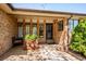 Inviting front porch area with stylish brickwork, decorative plants, and a cozy seating space at 2615 Oak Dr # 7, Lakewood, CO 80215
