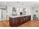 Elegant kitchen with a large central island, custom cabinetry, and pendant lighting at 2615 Oak Dr # 7, Lakewood, CO 80215
