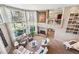 Spacious living room with floor-to-ceiling windows, a fireplace, and neutral furnishings at 2615 Oak Dr # 7, Lakewood, CO 80215