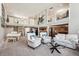 Spacious living room with soaring ceilings, second-story landing, piano and large windows providing natural light at 2615 Oak Dr # 7, Lakewood, CO 80215