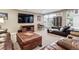 Living room featuring hardwood floors, an entertainment area, leather furniture, and large windows providing lots of natural light at 2615 Oak Dr # 7, Lakewood, CO 80215