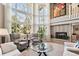 Bright and airy living room with soaring windows and cozy seating around a fireplace at 2615 Oak Dr # 7, Lakewood, CO 80215