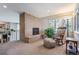 Cozy living room with brick fireplace, rocking chair and natural light from large window at 2615 Oak Dr # 7, Lakewood, CO 80215