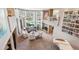 Large living room with high ceilings, a brick fireplace, and a wall of windows for natural light at 2615 Oak Dr # 7, Lakewood, CO 80215