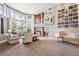 Spacious living room with a fireplace, tall windows, and an open floor plan, great for entertaining at 2615 Oak Dr # 7, Lakewood, CO 80215