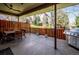 Back patio featuring a wooden fence, trees, a grill, and an outdoor dining table with chairs at 2615 Oak Dr # 7, Lakewood, CO 80215