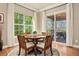 A breakfast nook with a wood table, seating for four, and a sliding glass door leading to the patio at 4965 Bierstadt Loop, Broomfield, CO 80023