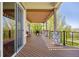 Covered patio features wood-style floorboards, metal railings, and stone columns, offering beautiful outdoor dining at 4965 Bierstadt Loop, Broomfield, CO 80023
