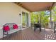 Comfortable covered patio includes a patio set and bench with vibrant red cushions, offering a great place to relax at 4965 Bierstadt Loop, Broomfield, CO 80023