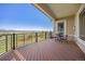 Open deck with mountain views features wood-style floorboards and metal railings for safety and beauty at 4965 Bierstadt Loop, Broomfield, CO 80023