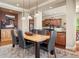 A dining room with wood floors and an area rug under a wood table with seating for six at 4965 Bierstadt Loop, Broomfield, CO 80023