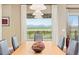 A dining room with views of the mountains, wood floors, and seating for six at 4965 Bierstadt Loop, Broomfield, CO 80023