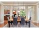 A dining room with a wood table, six chairs, a decorative rug and pendant lights above the table at 4965 Bierstadt Loop, Broomfield, CO 80023