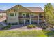 Beautiful tan home featuring a spacious deck with stone pillars and a well-maintained, xeriscaped yard at 4965 Bierstadt Loop, Broomfield, CO 80023