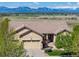 A cozy house showcasing a three-car garage, with a stunning mountain view at 4965 Bierstadt Loop, Broomfield, CO 80023