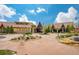 Front exterior view of community club house with a landscaped yard and circular driveway at 4965 Bierstadt Loop, Broomfield, CO 80023