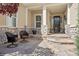 Inviting front porch with stone accents and comfortable seating area at 4965 Bierstadt Loop, Broomfield, CO 80023
