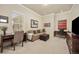 A living room with a sofa, desks, and artwork on the walls, all illuminated with natural light at 4965 Bierstadt Loop, Broomfield, CO 80023
