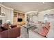 Comfortable living room boasts built-in shelving, fireplace, and ample seating at 4965 Bierstadt Loop, Broomfield, CO 80023