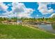 Scenic pond with cascading waterfall, lush greenery, and blue sky with clouds at 4965 Bierstadt Loop, Broomfield, CO 80023