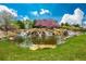 Beautiful water feature with rocks, waterfall, and blooming cherry tree at 4965 Bierstadt Loop, Broomfield, CO 80023